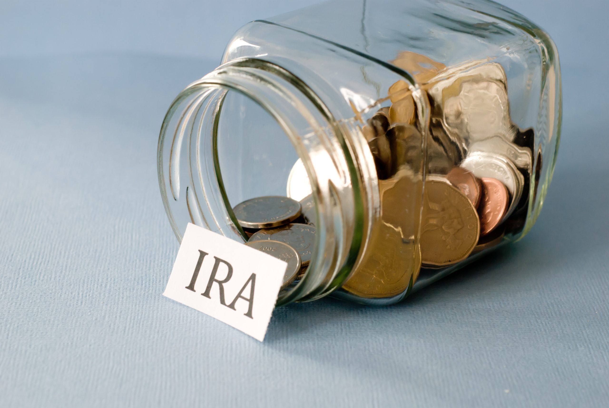Jar of money with IRA sign in front