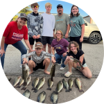 Picture of Lanette and family showing the fish they caught.