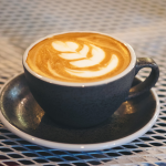 Picture of a design in froth on coffee in a coffee cup.